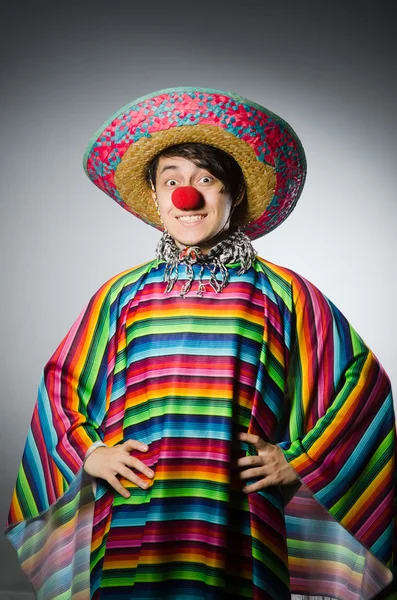 Man in vivid mexican poncho against gray — Stock Photo, Image