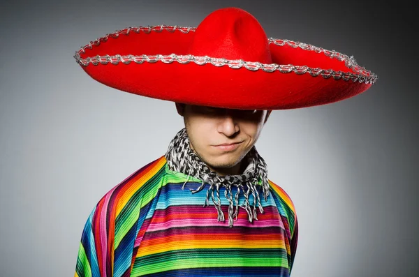 Homem em vívido poncho mexicano contra cinza — Fotografia de Stock