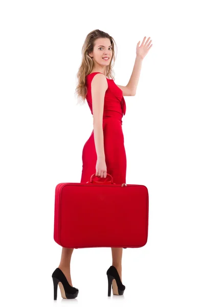 Young woman in red dress with suitcase isolated on white — Stock Photo, Image