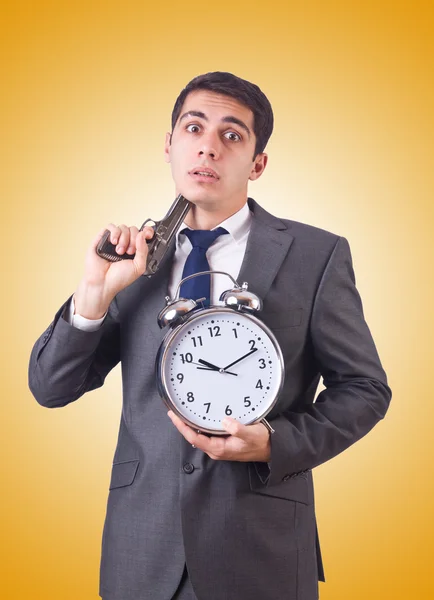 Man with gun and clock — Stock Photo, Image