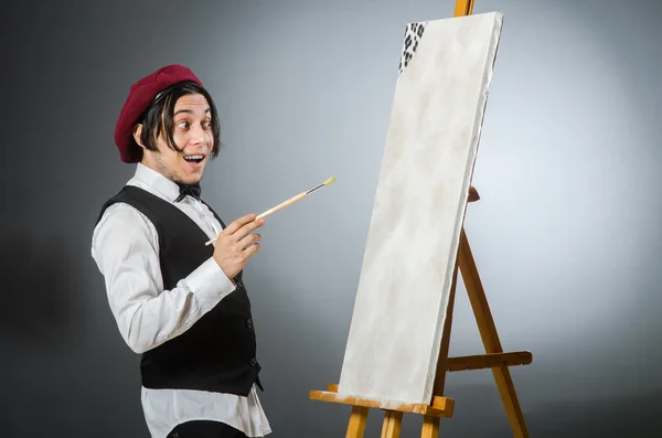 Funny artist in dark studio — Stock Photo, Image