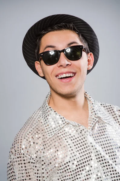 Молодой человек в серебряной рубашке и шляпе — стоковое фото