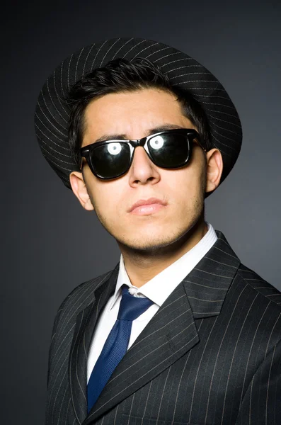 Young man in elegant suit against gray Stock Image