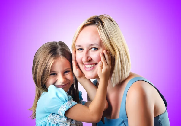 Happy mom and daughter on purple — Stock Photo, Image