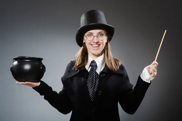 Harry Potter girl with magic stick and pot against gray — Stock Photo, Image