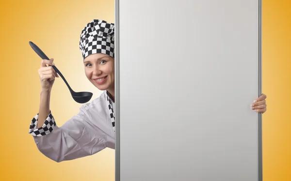 Cook with ladle and blank board — Stock Photo, Image