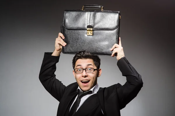 Businessman with handbag against gray — Stock Photo, Image