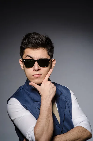 Young man in blue vest against gray — Stock Photo, Image