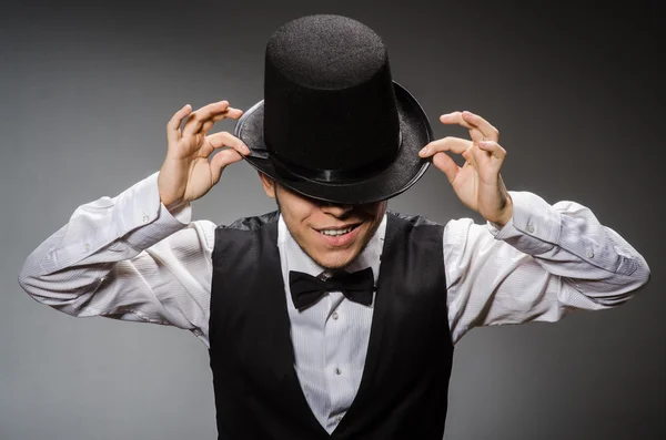 Young man in classical black vest and hat against gray — Stock Photo, Image