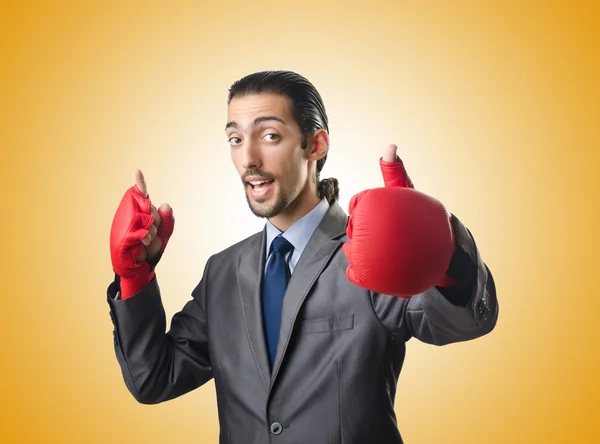 Handsome businessman with boxing gloves — Stock Photo, Image