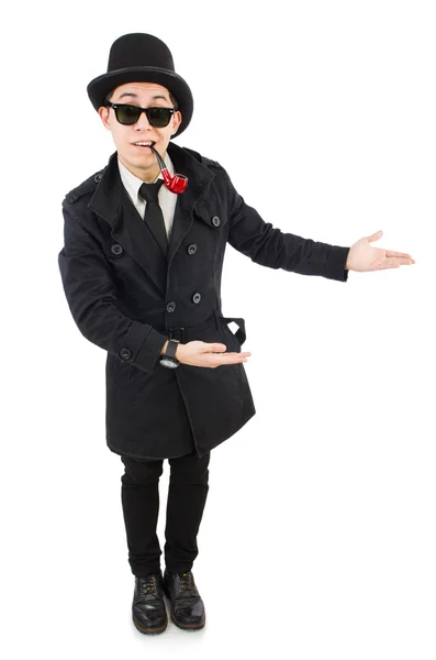 Молодий детектив в чорному пальто тримає збільшувальне скло ізольовано — стокове фото
