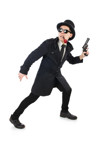 Giovane detective in cappotto nero con pistola isolata su bianco — Foto Stock