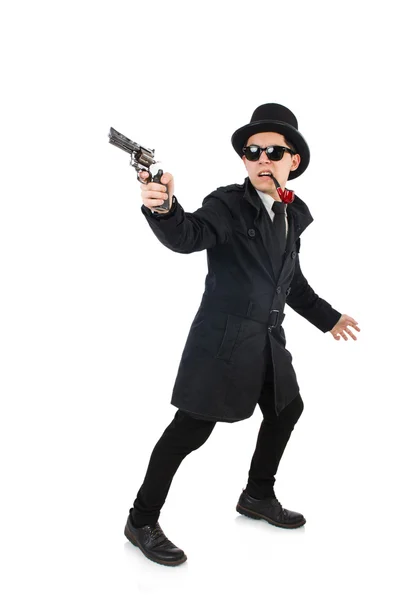 Giovane detective in cappotto nero con pistola isolata su bianco — Foto Stock