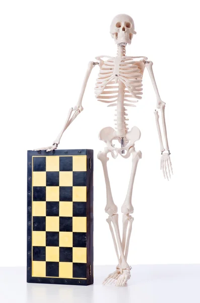 Skeleton scratches head trying to figure out next chess move Stock Photo -  Alamy