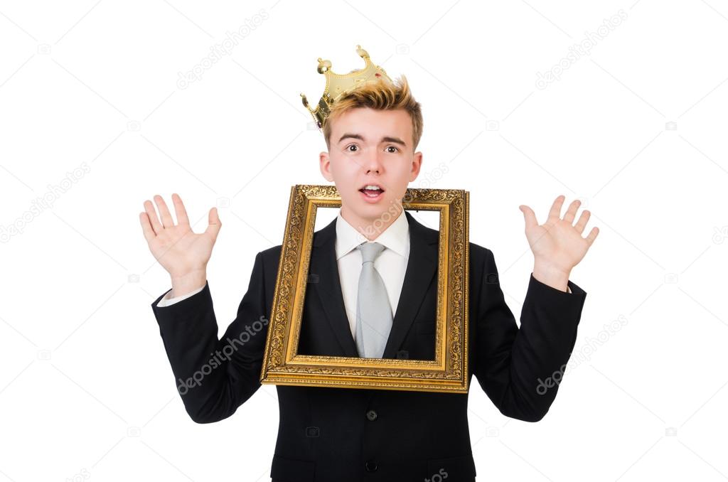Young businessman with crown and picture frame isolated on white