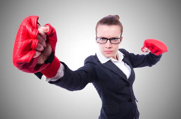 Woman with boxing gloves on white