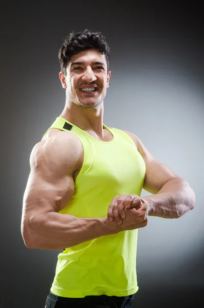 Homem muscular posando em estúdio escuro — Fotografia de Stock