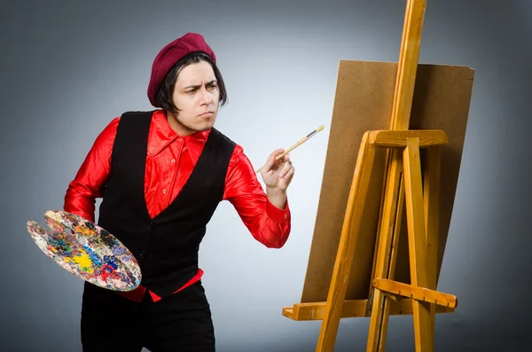 Funny artist in dark studio — Stock Photo, Image