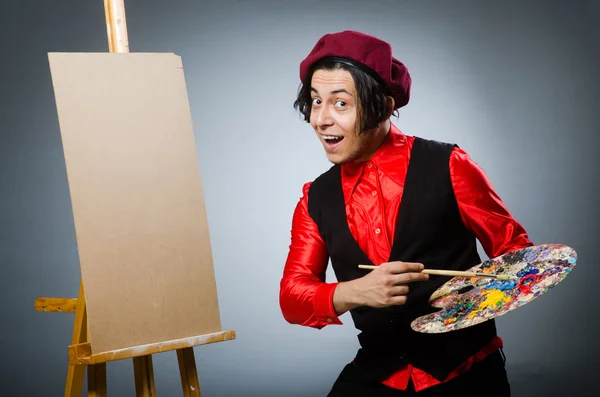 Funny artist in dark studio — Stock Photo, Image