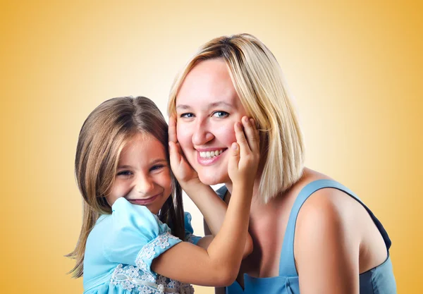 Happy mom and daughter on yellow — Stock Photo, Image