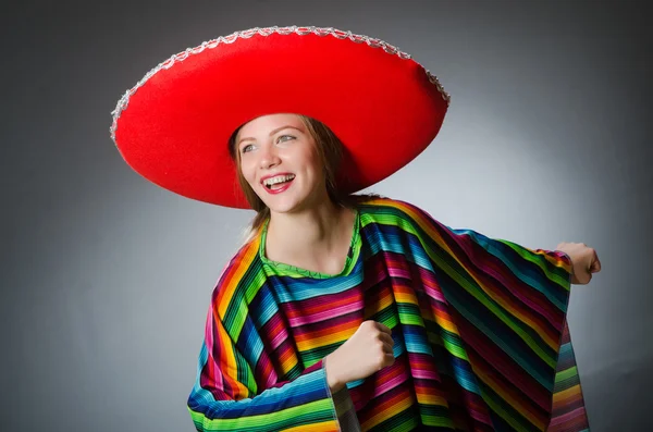 Girl in mexican vivid poncho against gray — Stock Photo, Image