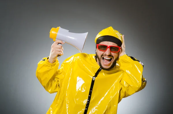 Man wearing yellow suit with loudspeaker — Stock Photo, Image