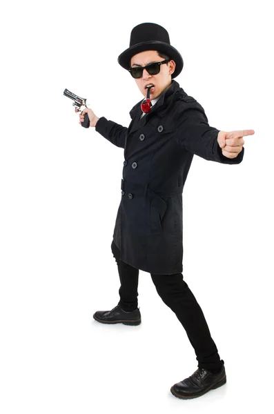 Giovane detective in cappotto nero con pistola isolata su bianco — Foto Stock