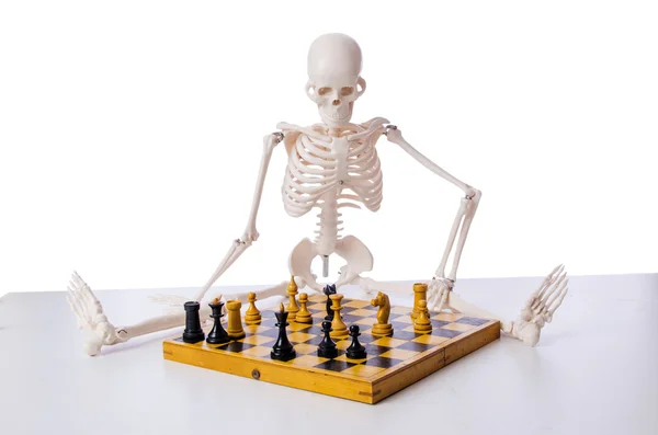 Skeleton scratches head trying to figure out next chess move Stock Photo -  Alamy