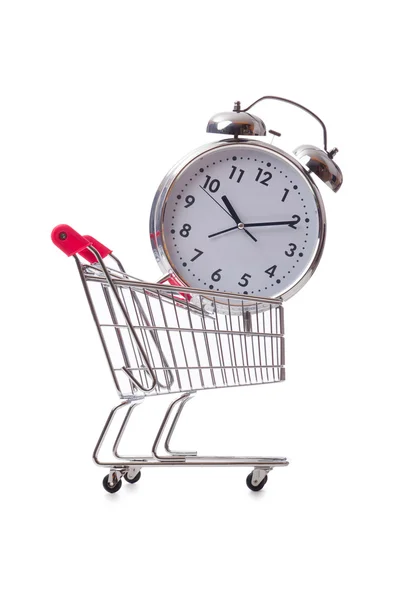 Big alarm clock in shopping cart on white — Stock Photo, Image