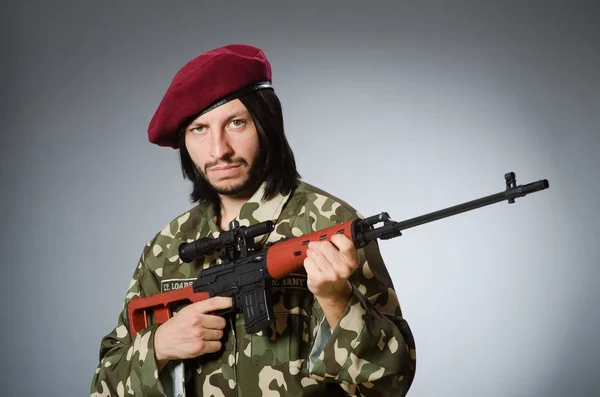 Soldier with handgun against gray — Stock Photo, Image