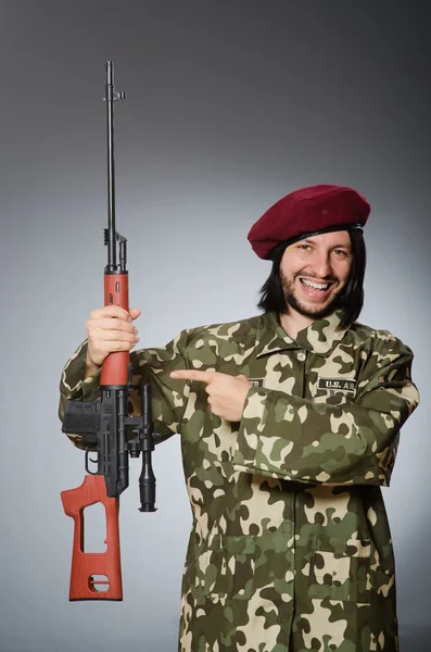 Soldier with handgun against gray — Stock Photo, Image