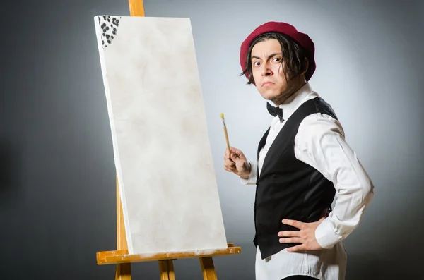 Funny artist in dark studio — Stock Photo, Image