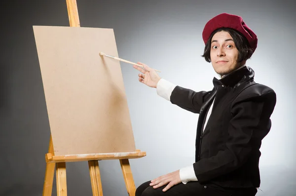 Funny artist in dark studio — Stock Photo, Image