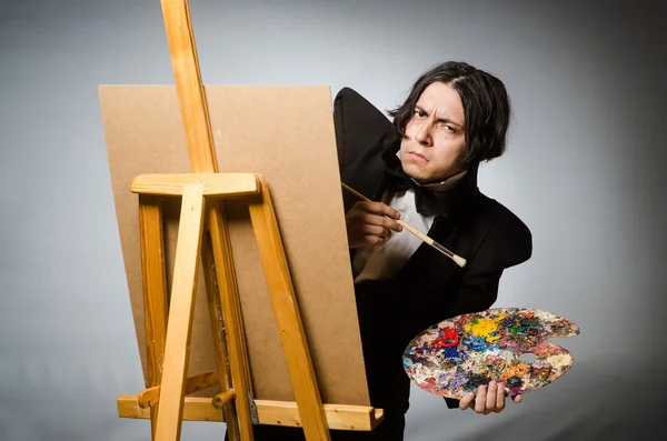 Funny artist in dark studio — Stock Photo, Image