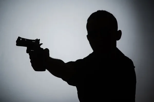 Sombra del hombre con arma —  Fotos de Stock