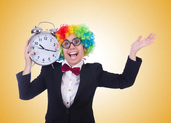 Funny clown with clock on white — Stock Photo, Image