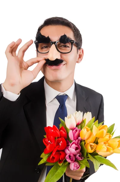 Homem engraçado com flores isoladas em branco — Fotografia de Stock