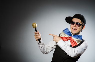 Karaoke konseptinde mikrofonlu komik adam