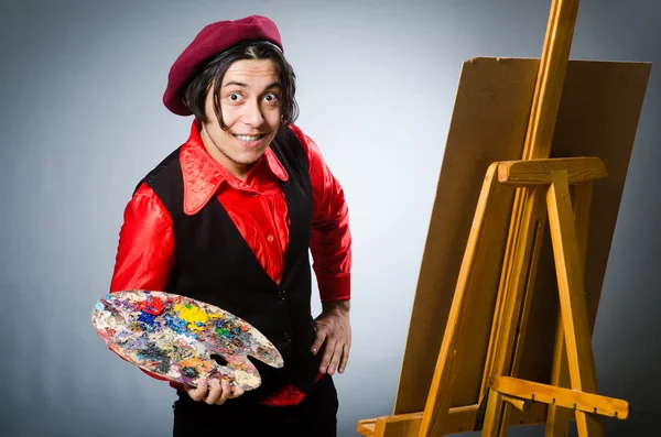 Funny artist in dark studio — Stock Photo, Image