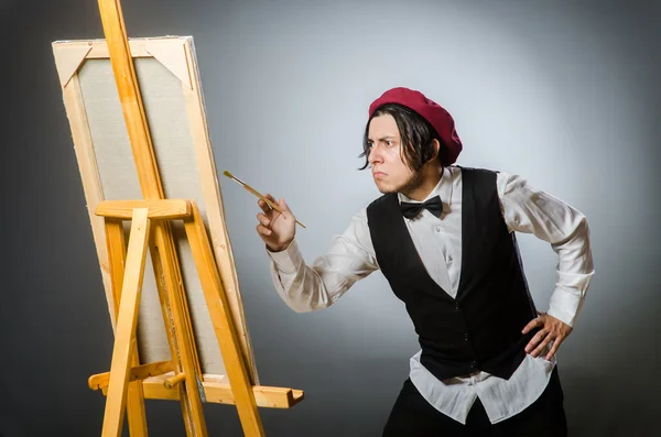 Funny artist in dark studio — Stock Photo, Image