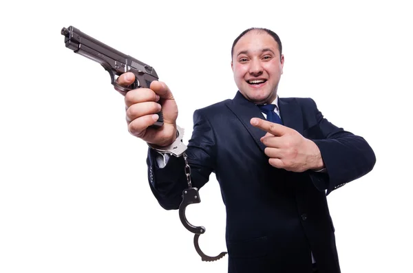 Mann mit Waffe und Handschellen auf weiß — Stockfoto