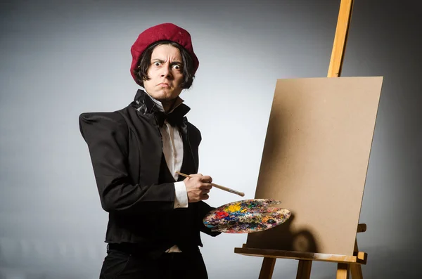 Funny artist in dark studio — Stock Photo, Image