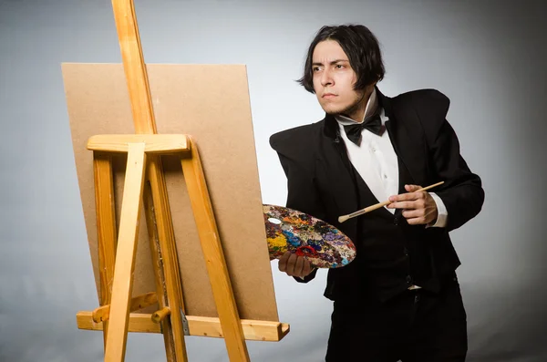 Funny artist in dark studio — Stock Photo, Image