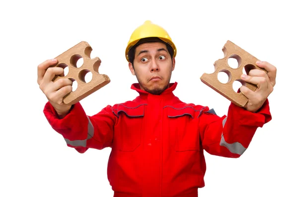 Construction worker with clay bricks on white — Stock Photo, Image