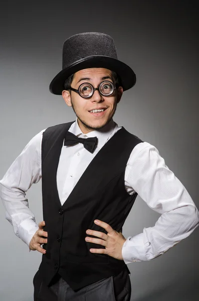 Young man in classical black vest and hat against gray — Stock Photo, Image