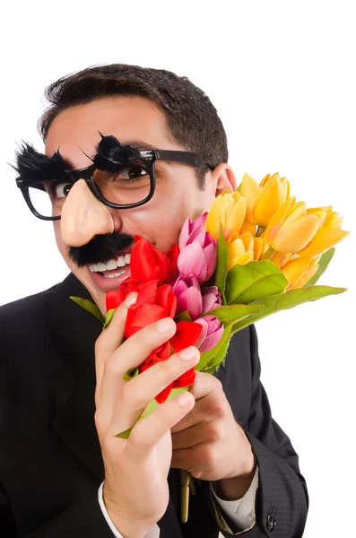 Grappige mens met bloemen geïsoleerd op wit — Stockfoto