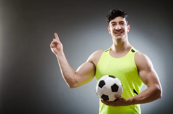 Muscular man with football ball — Stock Photo, Image