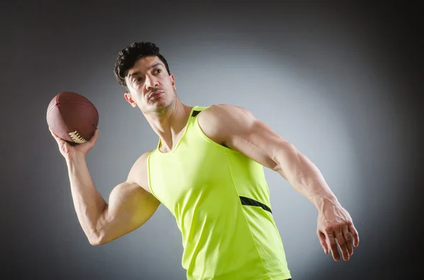 Muscular man with american football — Stock Photo, Image