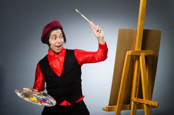 Funny artist in dark studio — Stock Photo, Image