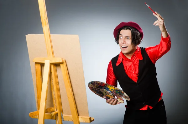 Funny artist in dark studio — Stock Photo, Image